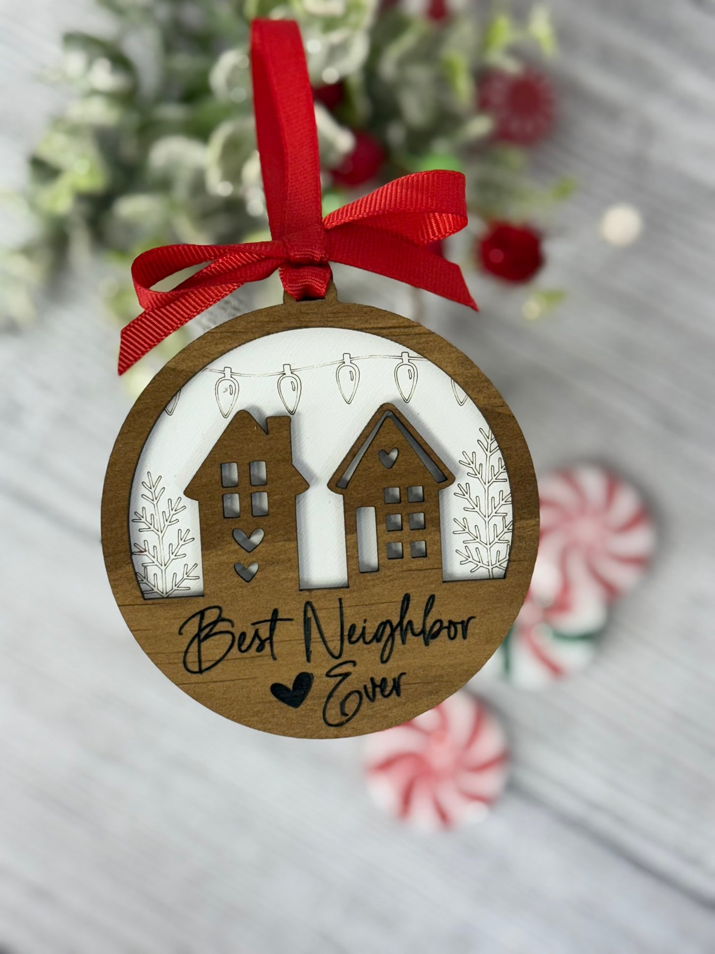 Best Neighbor Ever ornament with two wooden houses layered on white background