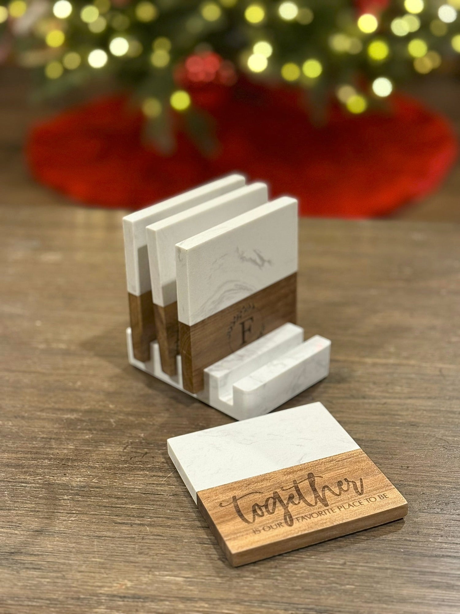 The Creative Nook personalized marble and acacia wood coaster set with custom engraving and matching display base.