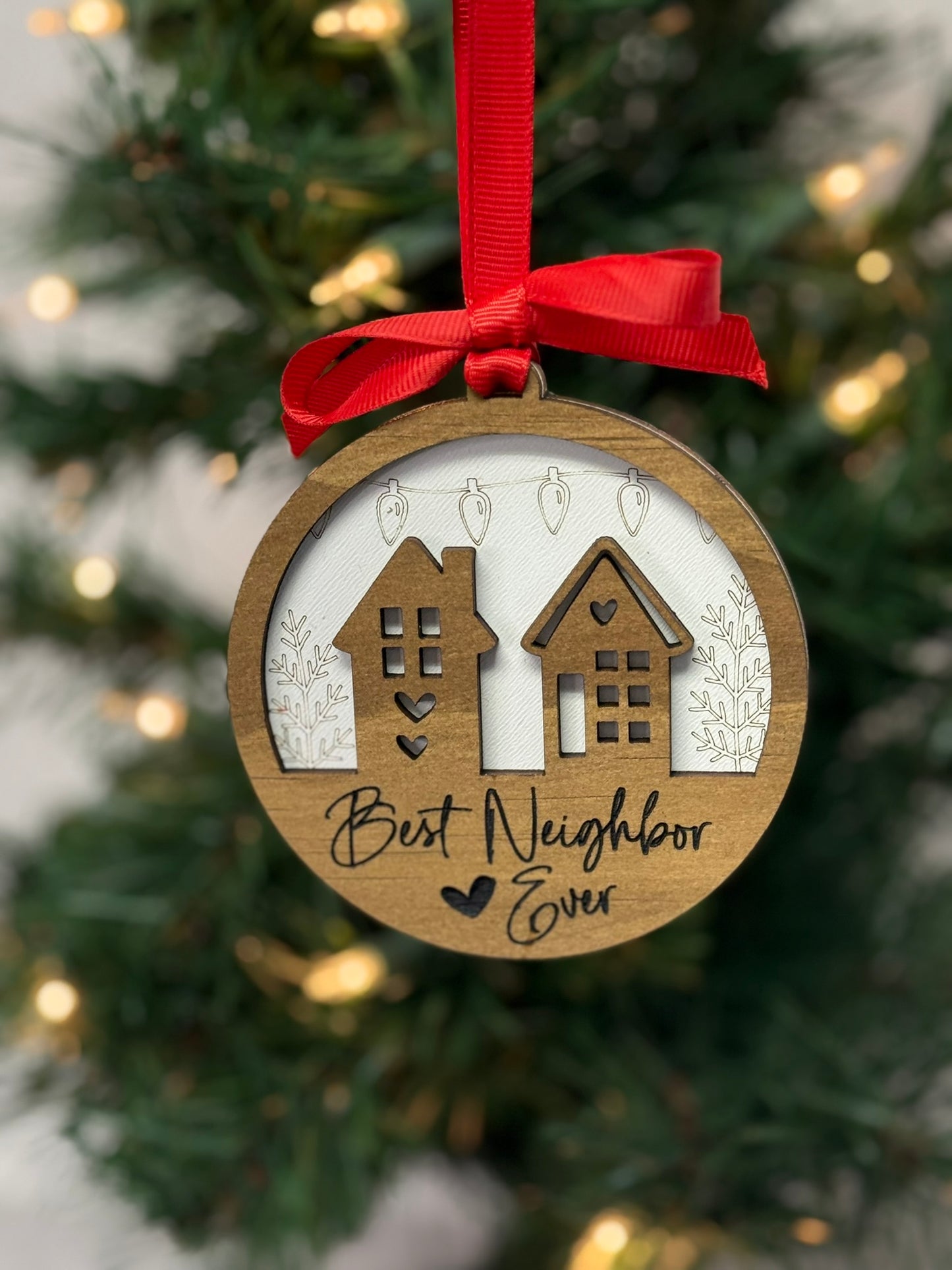 Best Neighbor Ever ornament with two wooden houses layered on white background