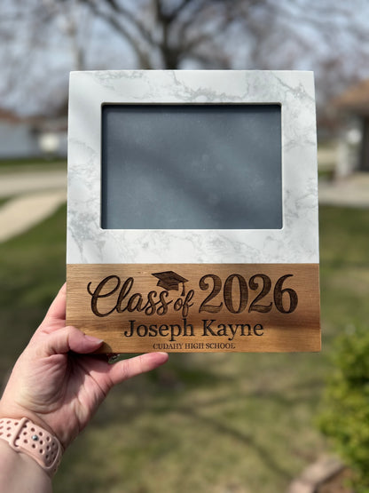 Close up of engraved Class of 2026 graduation frame showing custom name and school detail