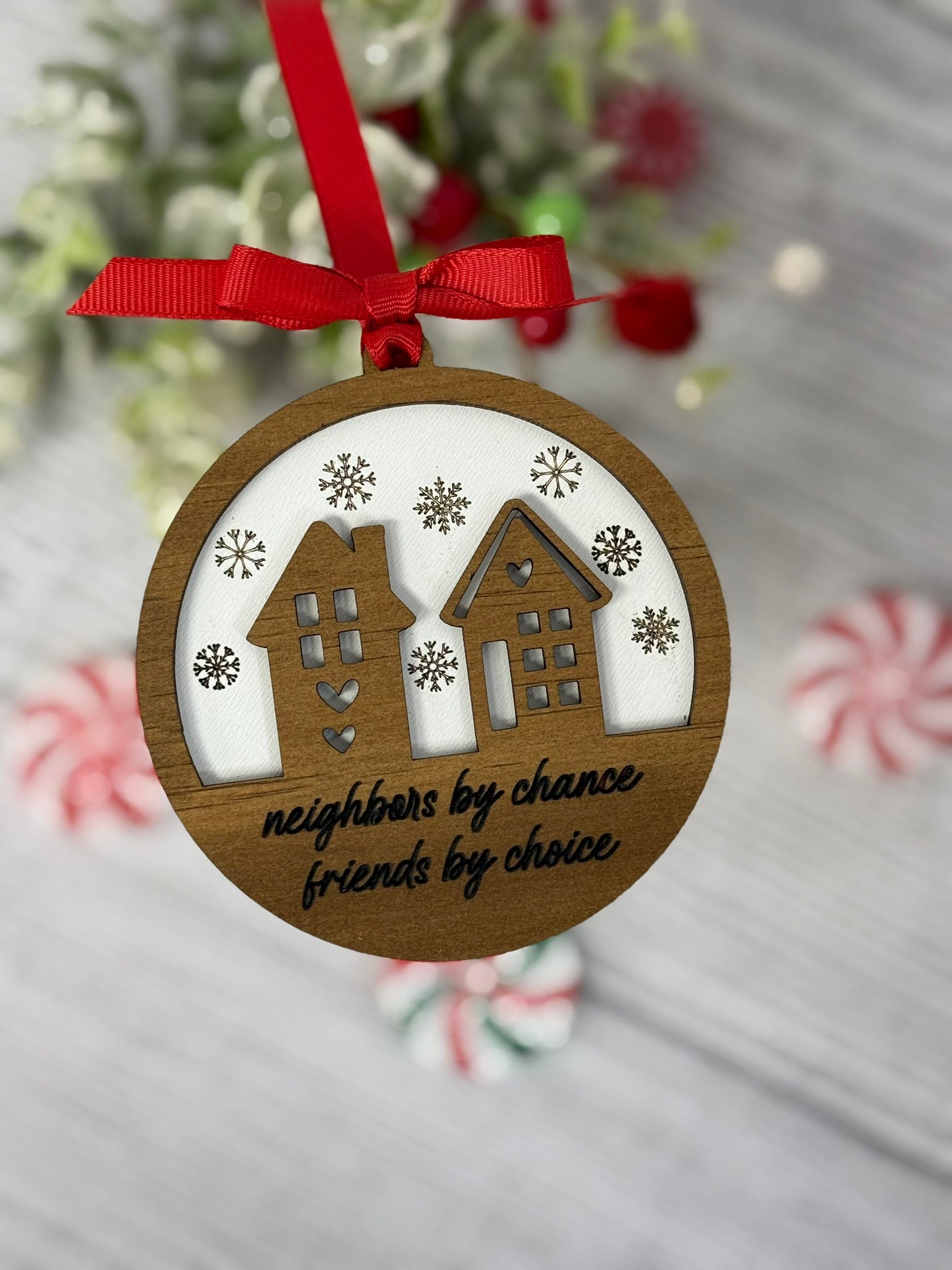 Neighbors by chance friends by choice ornament with wooden house overlay on white background