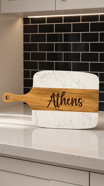 A personalized marble serving board with a wooden handle