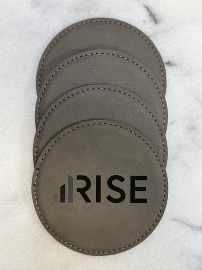 Custom engraved leatherette coasters with company logo for corporate gifting.