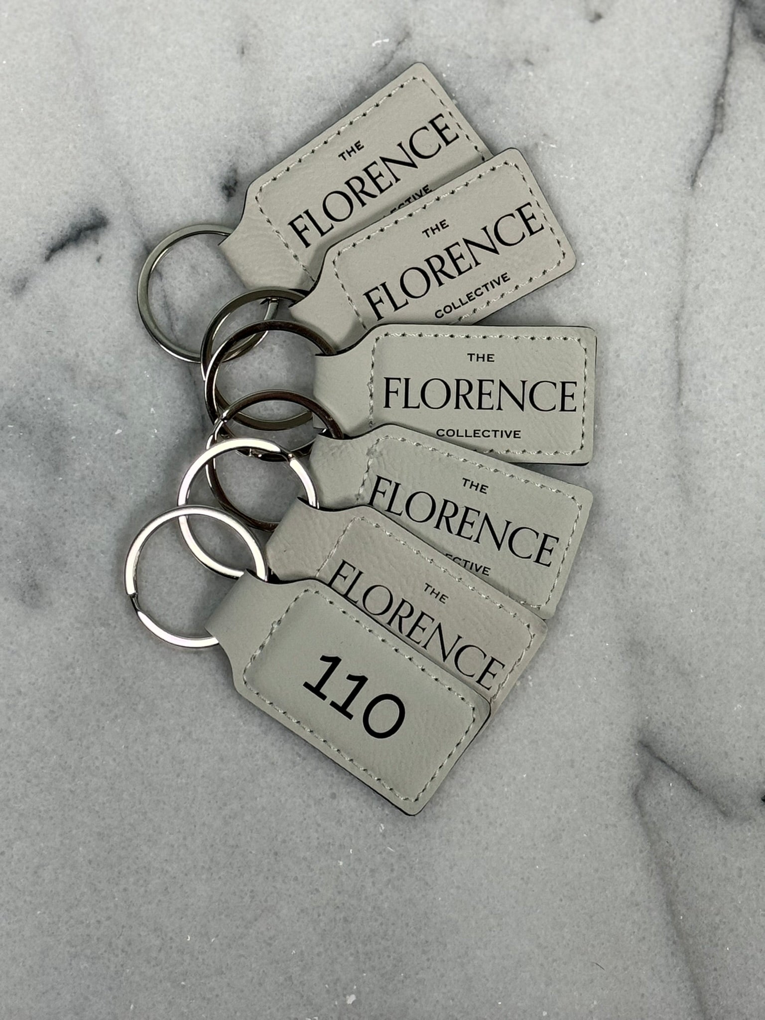 Front and back view of personalized leatherette rectangle keychain with custom engraving on both sides