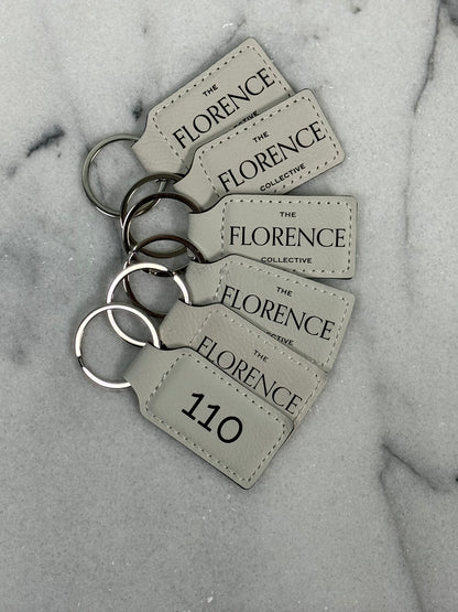 Front and back view of personalized leatherette rectangle keychain with custom engraving on both sides