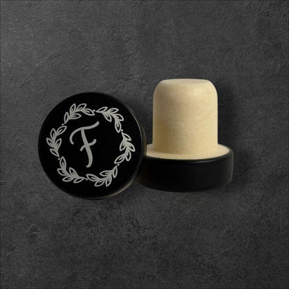 Black stainless steel wine bottle stopper with silver engraved monogram