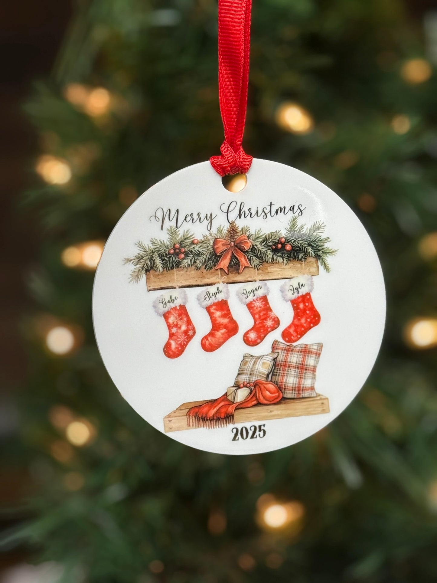 Personalized family Christmas stocking ornament on Christmas tree, white acrylic round with printed mantel scene and custom names.