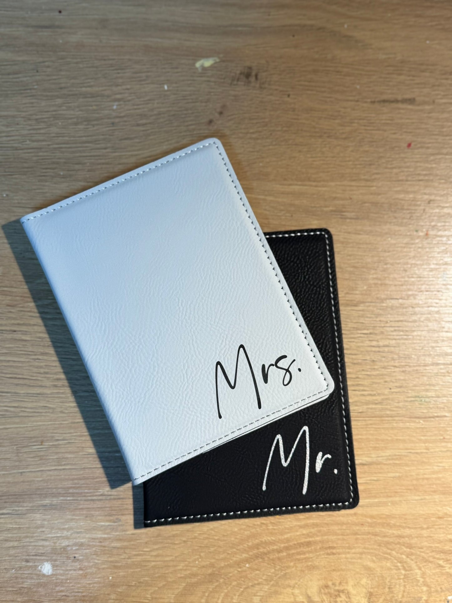 Coordinating his and hers personalized passport holders in complementary colors