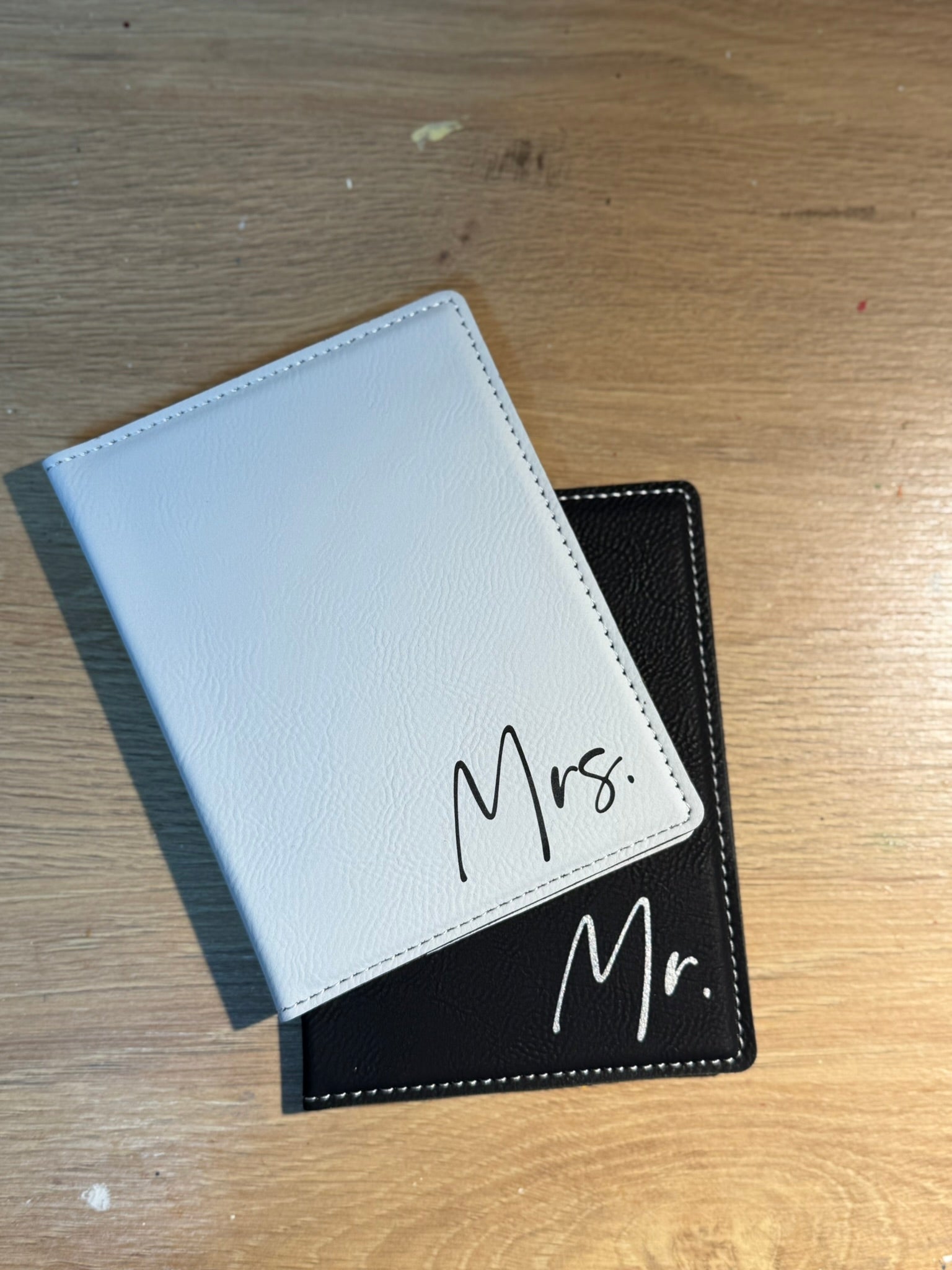 Coordinating his and hers personalized passport holders in complementary colors
