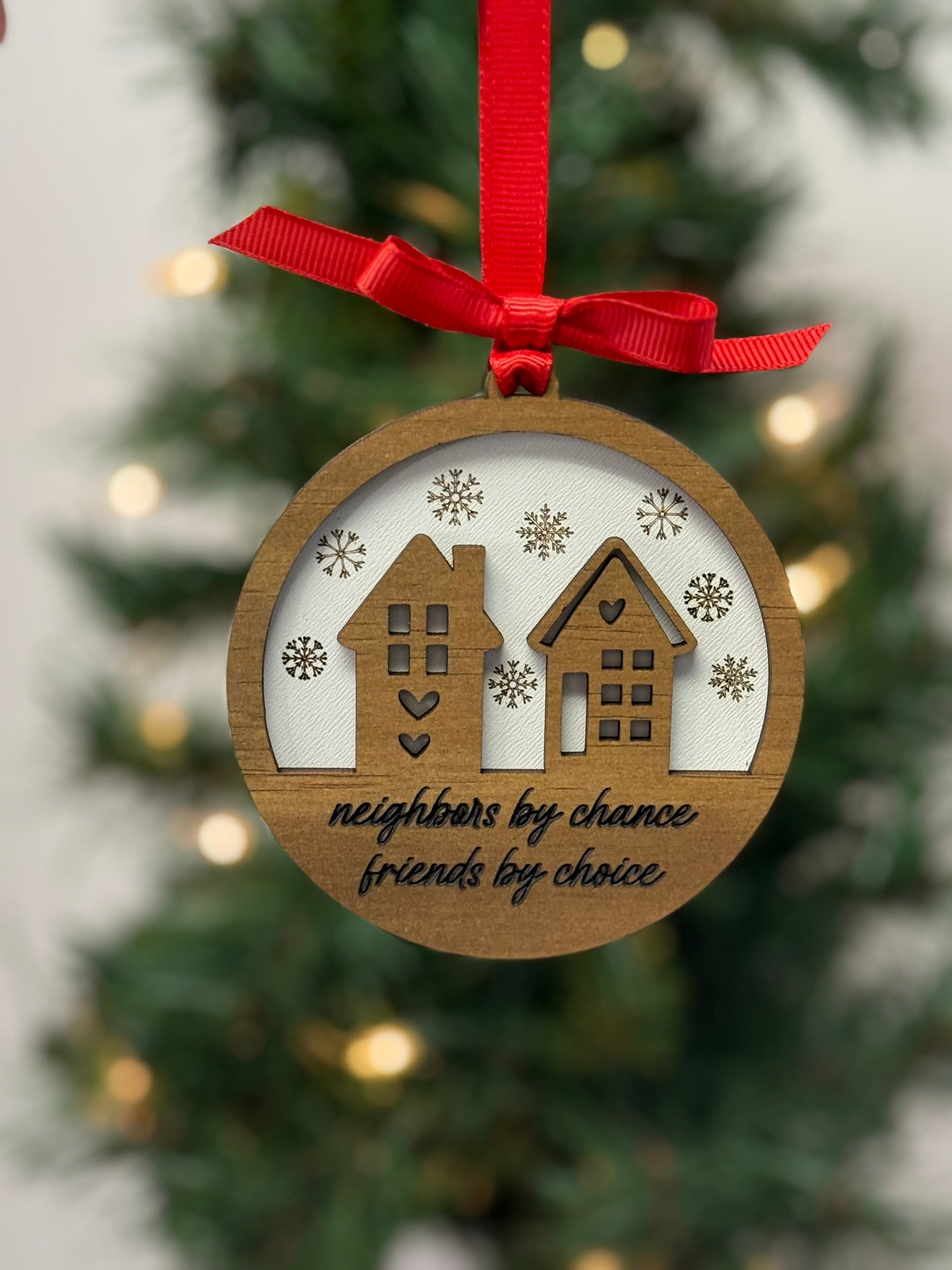 Neighbors by chance friends by choice ornament with wooden house overlay on white background