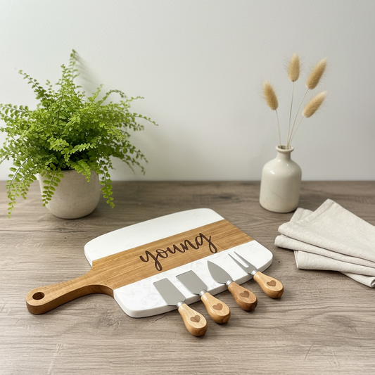 Personalized marble and acacia wood serving board with custom family name engraving and cheese knives