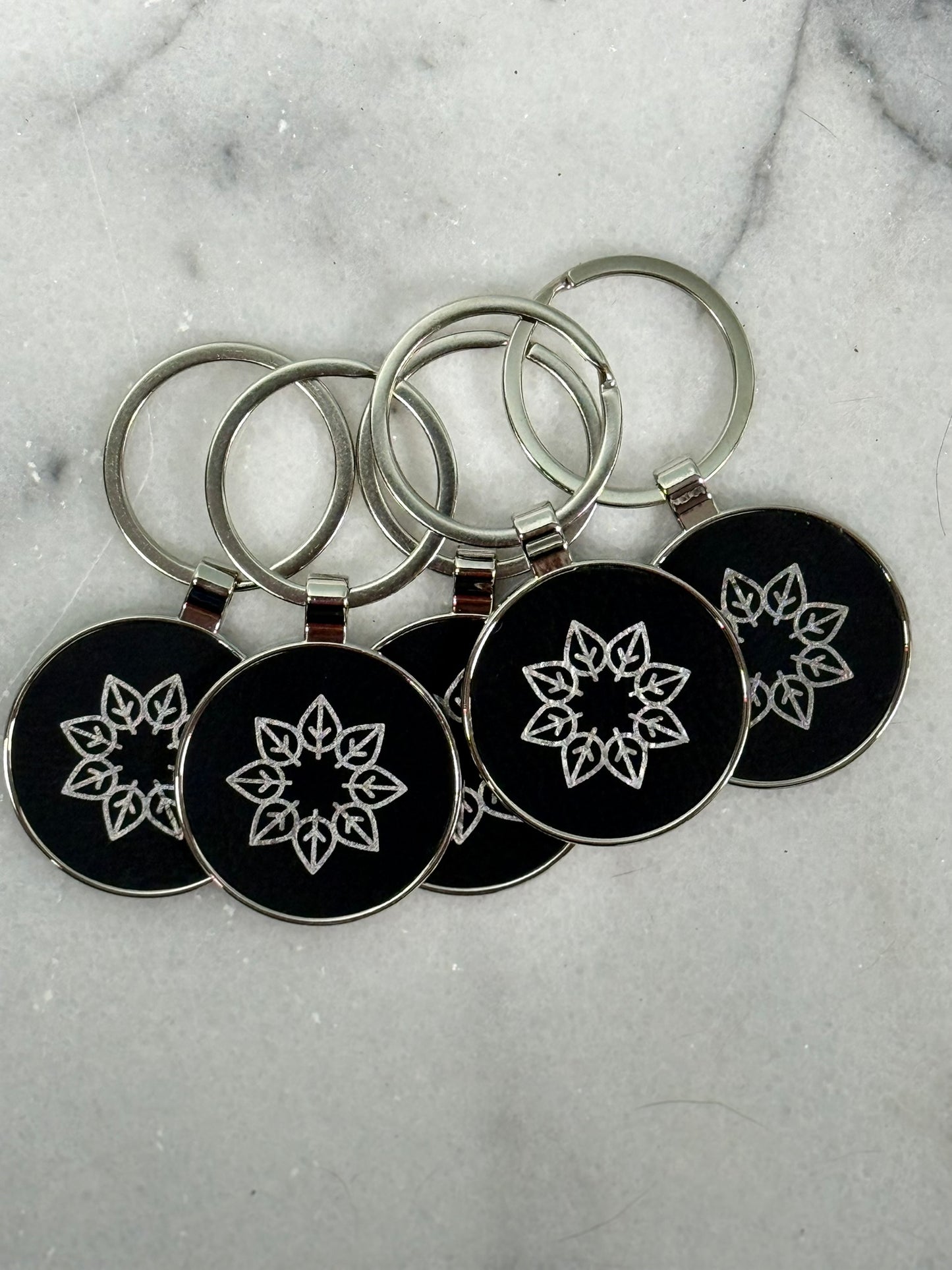 Personalized round engraved keychain attached to keys for business branding or gifts