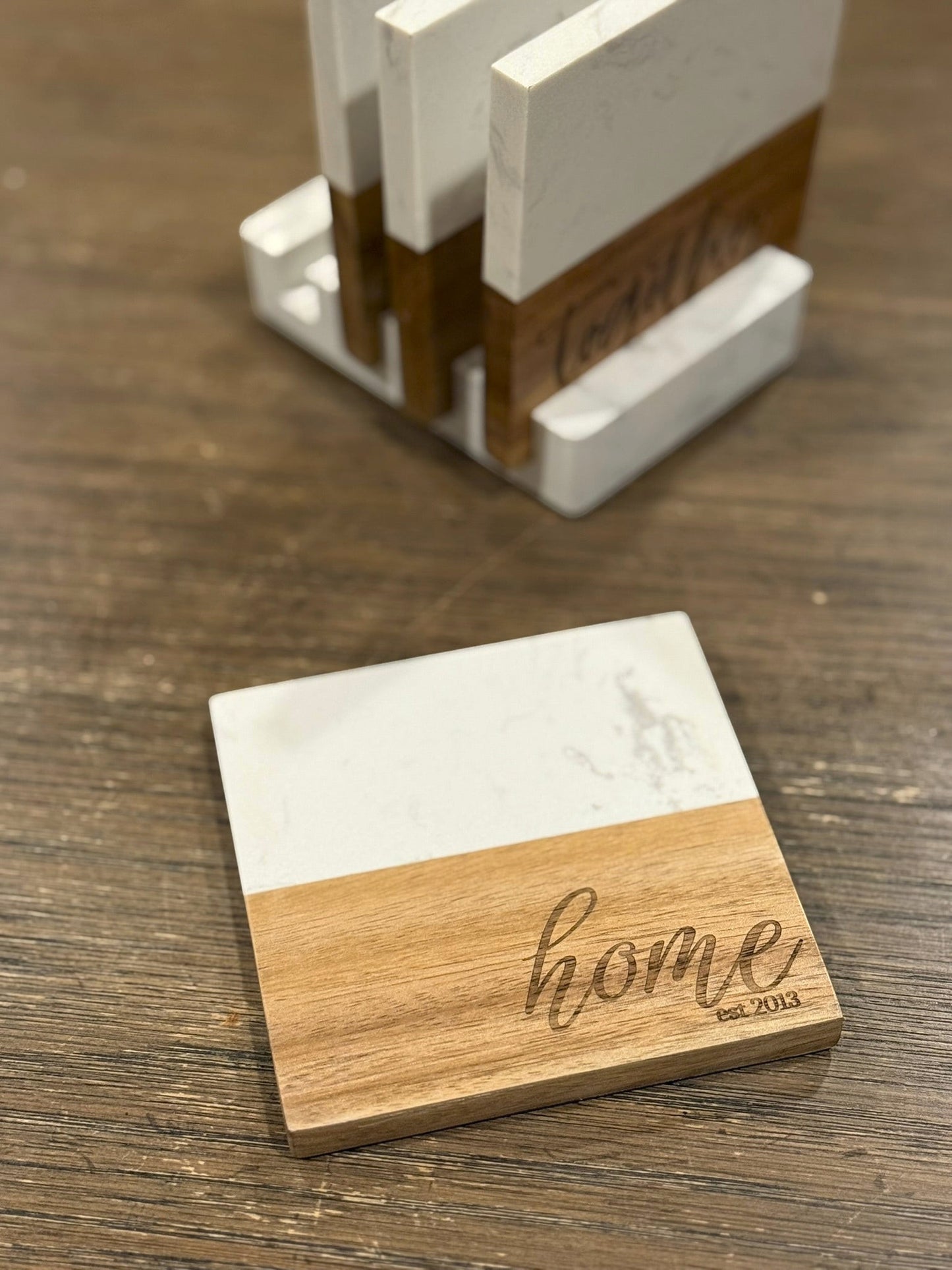 The Creative Nook personalized marble and acacia wood coaster set with engraved home text and storage base.