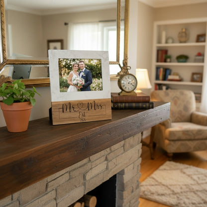 The Creative Nook personalized marble and wood photo frame engraved with Mr & Mrs on a rustic fireplace mantel.