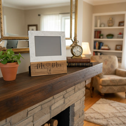 The Creative Nook personalized Mr. & Mrs. marble and wood photo frame on a rustic fireplace mantel.